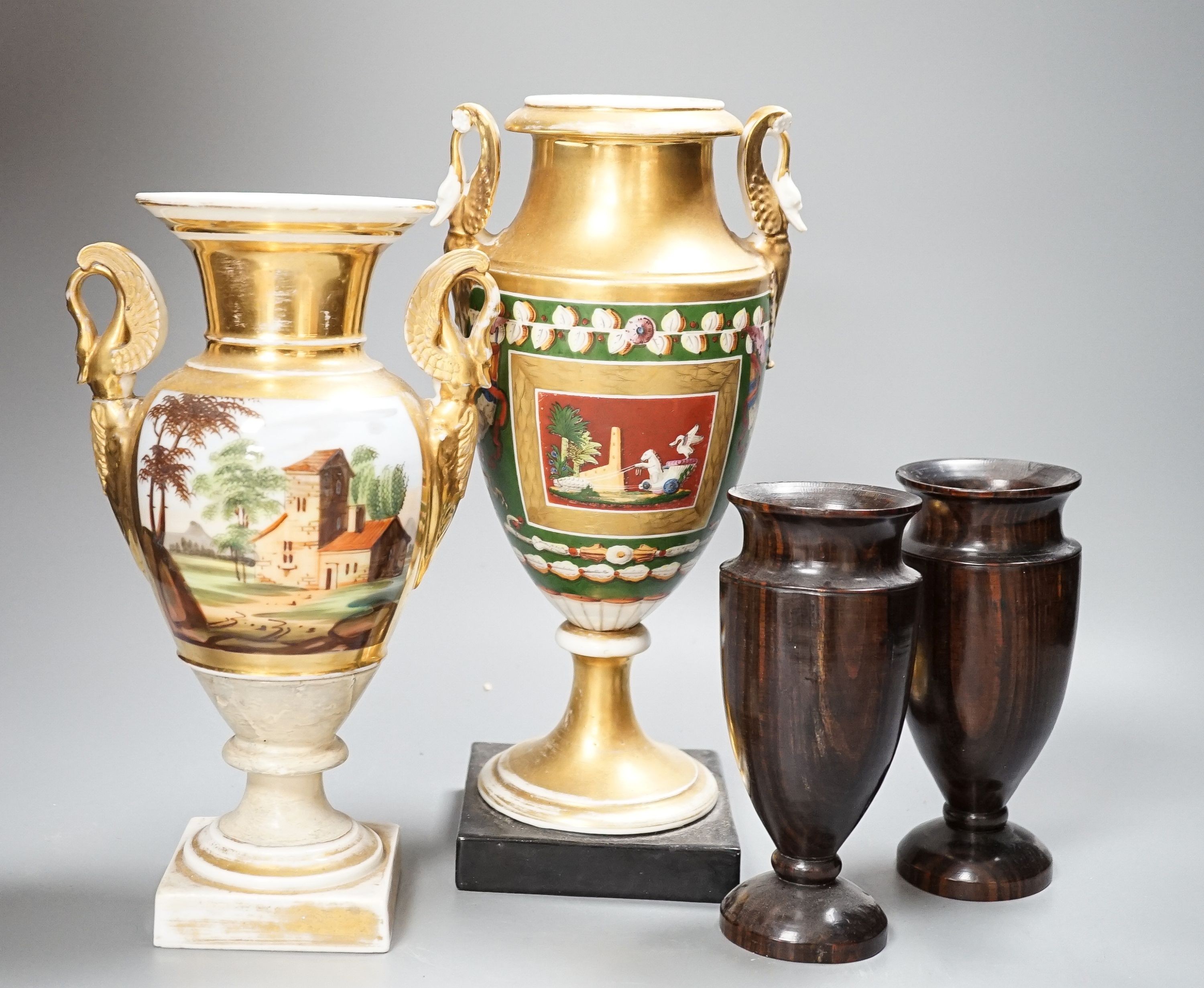 Two 19th century Paris porcelain gilt decorated swan-handled vases and a pair of turned ebony vases, tallest 28cm